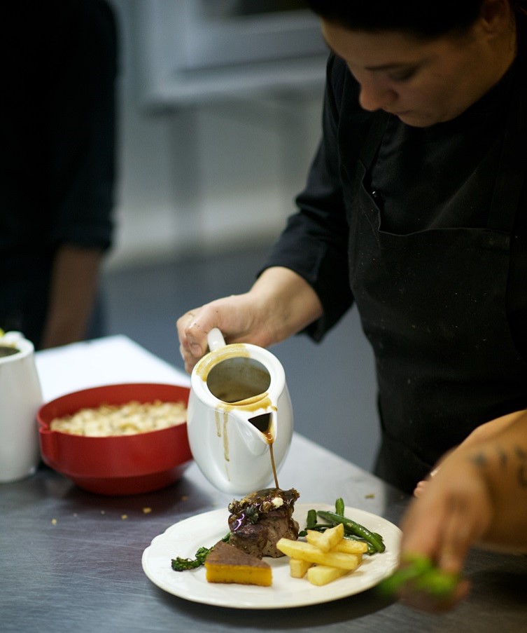 IWH Academy student, plating a delicious plate of food
