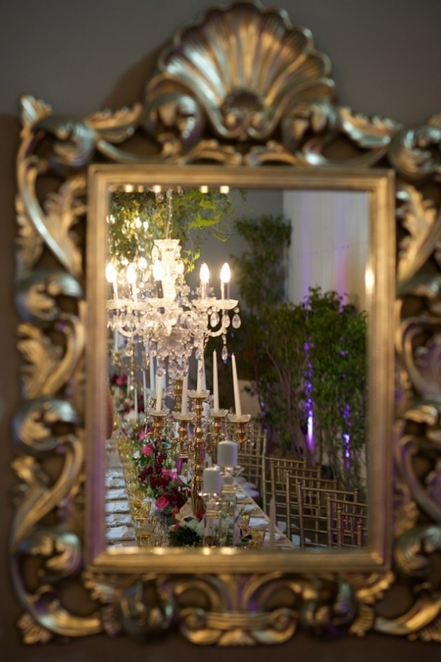 Photo taken through a mirror of a beautiful candle lit table